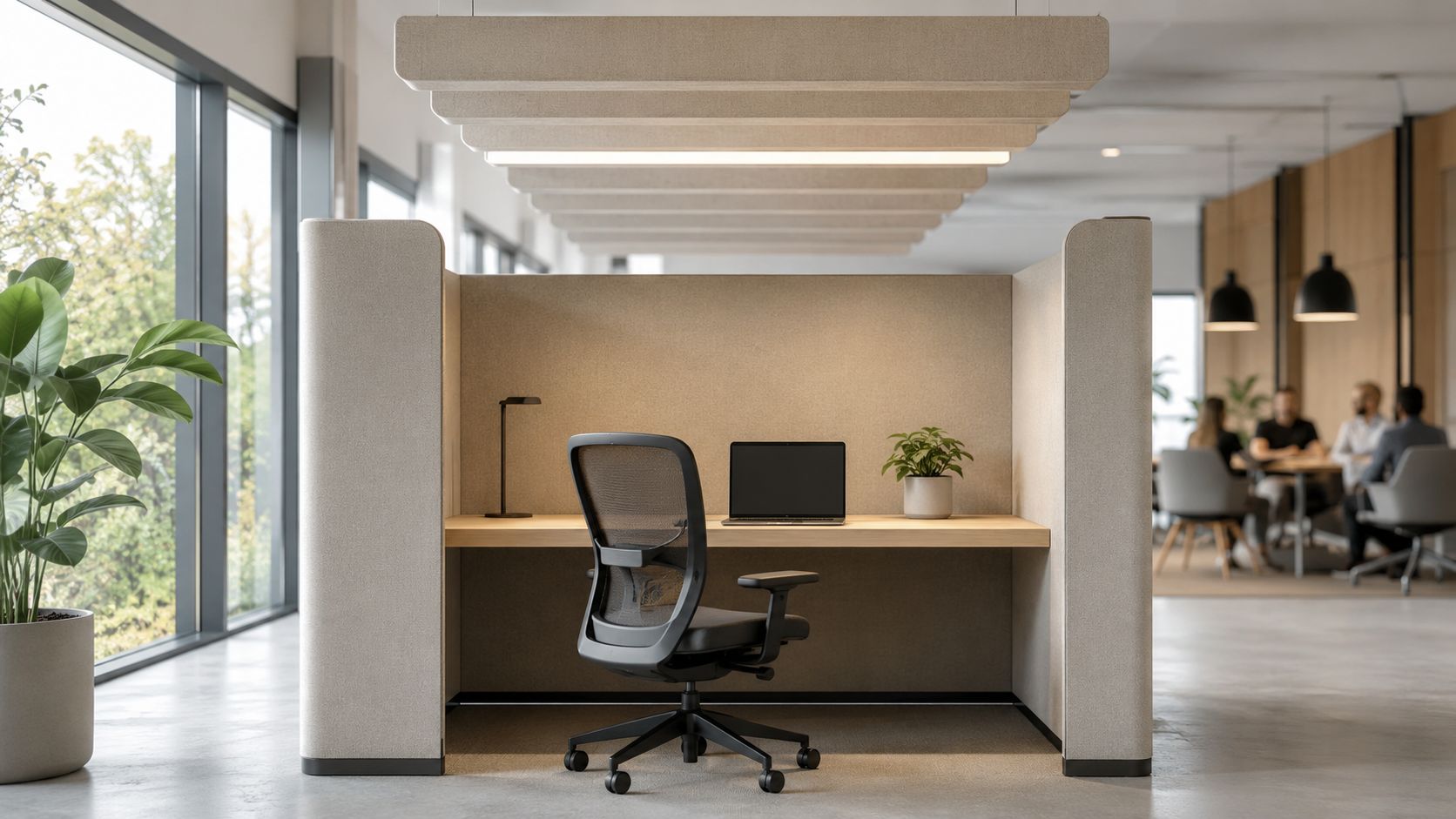 A modern, private acoustic office workspace pod featuring an ergonomic chair, laptop, and desk lamp.